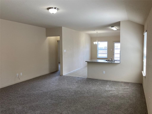 unfurnished room with light colored carpet and a sink