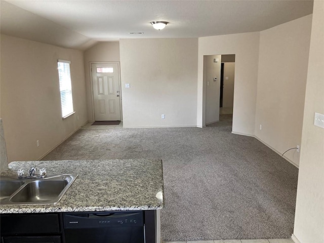 interior space with vaulted ceiling, carpet floors, and a sink