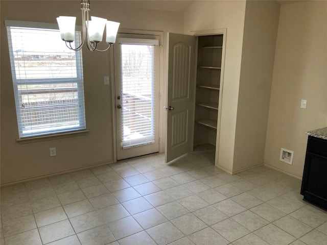 unfurnished dining area with built in shelves, a notable chandelier, light tile patterned floors, visible vents, and baseboards