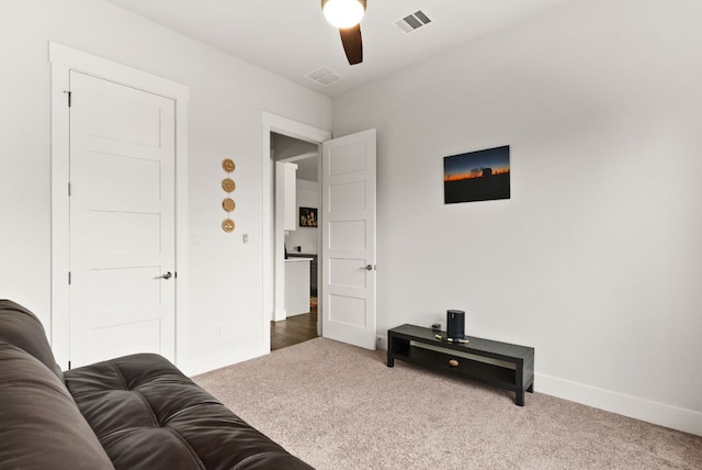 interior space featuring ceiling fan, carpet, visible vents, and baseboards