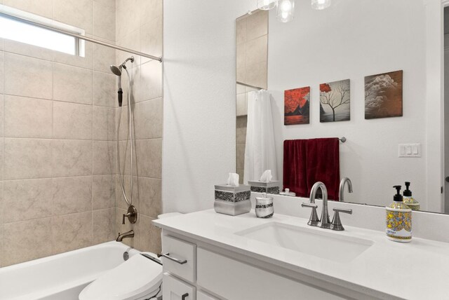 full bathroom featuring toilet, shower / bathtub combination with curtain, and vanity