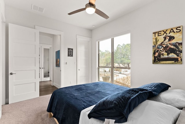 bedroom featuring ceiling fan, carpet floors, and visible vents