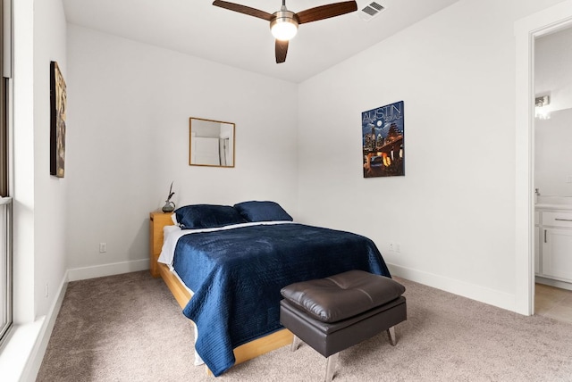 carpeted bedroom featuring baseboards, visible vents, ceiling fan, and ensuite bathroom