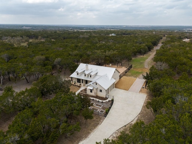 bird's eye view with a wooded view