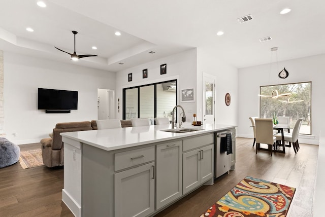 kitchen featuring dishwasher, a sink, visible vents, and a healthy amount of sunlight