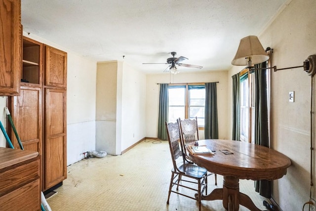 dining space with a ceiling fan and a textured ceiling