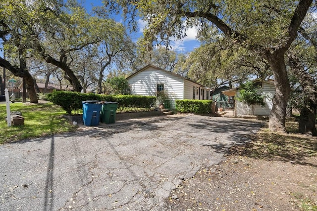 view of side of home with driveway