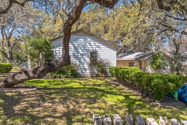 view of side of home featuring a lawn