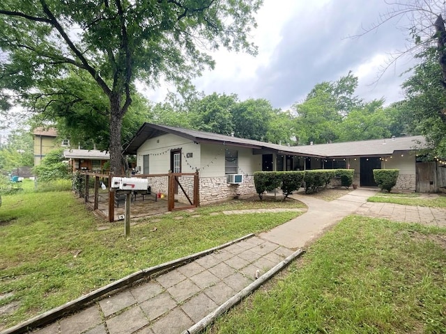 view of front of property featuring a front yard and stone siding