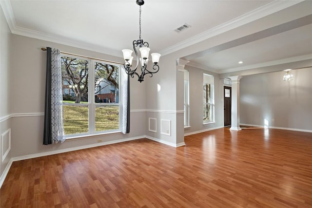 unfurnished dining area with baseboards, light wood-style floors, visible vents, and ornate columns