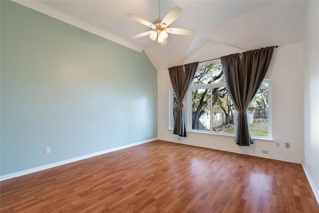 empty room with baseboards, a wealth of natural light, and wood finished floors