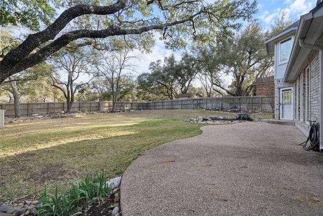 view of yard with a patio area and a fenced backyard