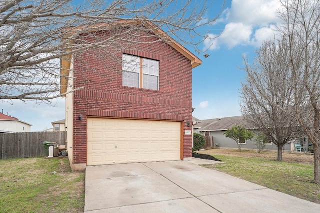 view of side of home featuring brick siding, a lawn, an attached garage, fence, and driveway