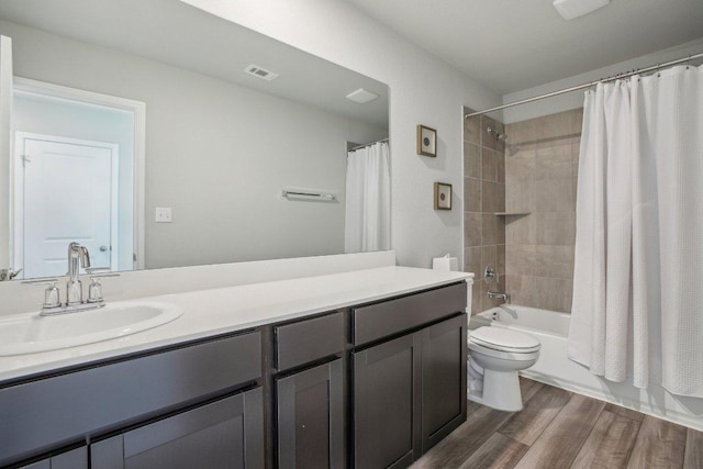 full bath with vanity, wood finished floors, visible vents, toilet, and shower / tub combo with curtain