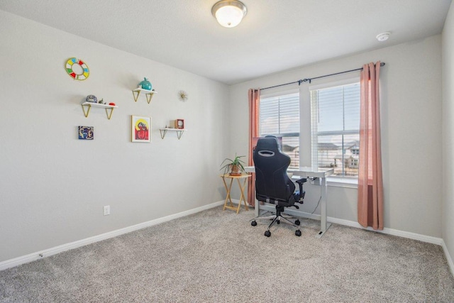 carpeted office featuring baseboards