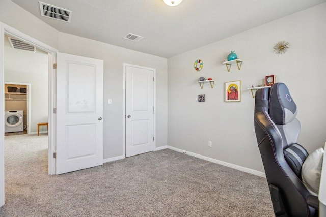 office space with visible vents, washer / clothes dryer, and carpet