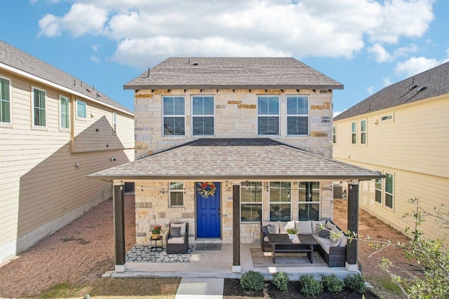 back of house featuring an outdoor living space, stone siding, a patio, and a shingled roof