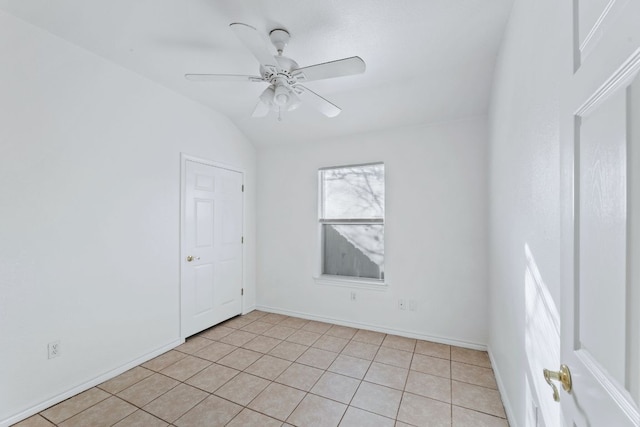 unfurnished room featuring vaulted ceiling, ceiling fan, baseboards, and light tile patterned floors