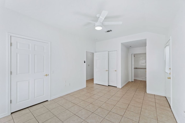 unfurnished bedroom featuring visible vents, ceiling fan, baseboards, and light tile patterned flooring