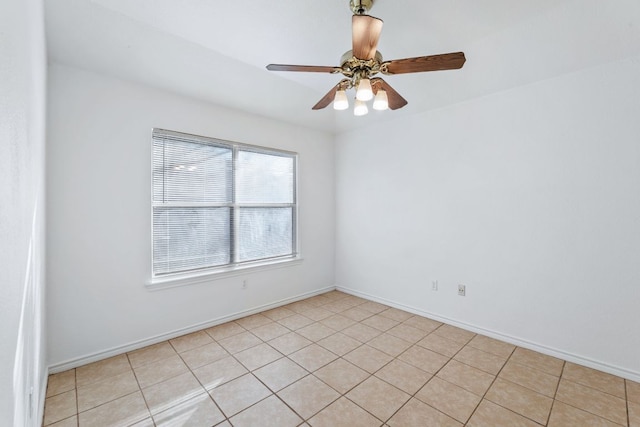 unfurnished room featuring ceiling fan and baseboards