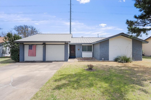 ranch-style house with a garage, concrete driveway, metal roof, a front lawn, and brick siding