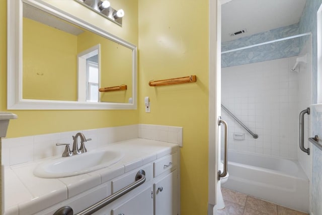 bathroom with visible vents, tub / shower combination, and vanity