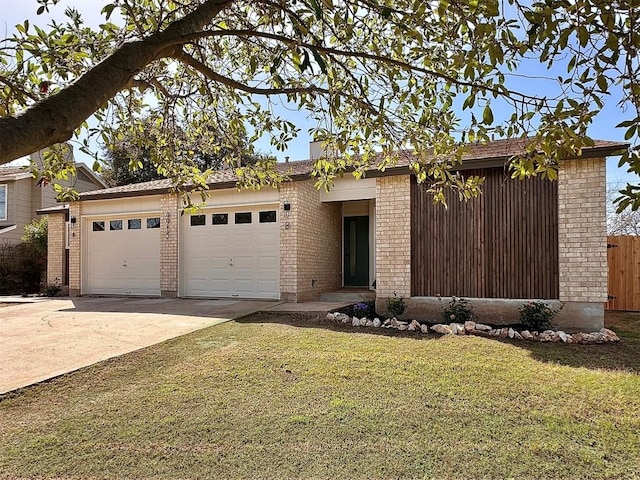 view of front of home featuring fence, concrete driveway, a front yard, a garage, and brick siding