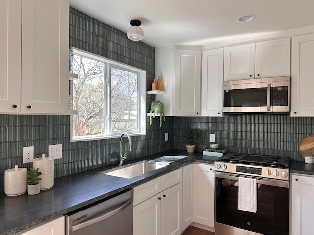 kitchen with white cabinets, stainless steel appliances, and a sink