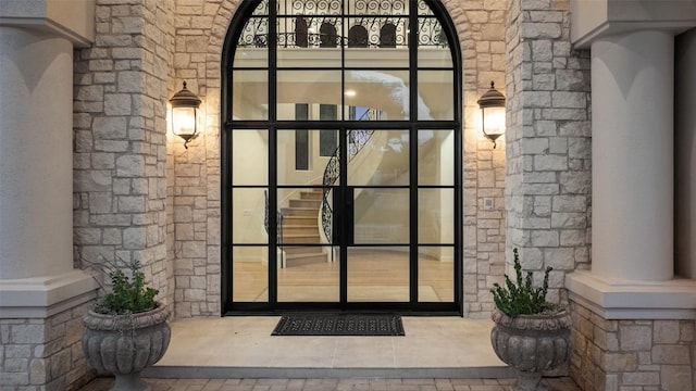doorway to property featuring stone siding