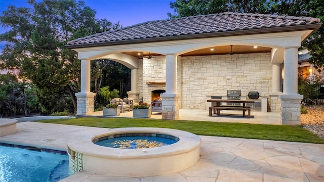 view of patio featuring an outdoor stone fireplace