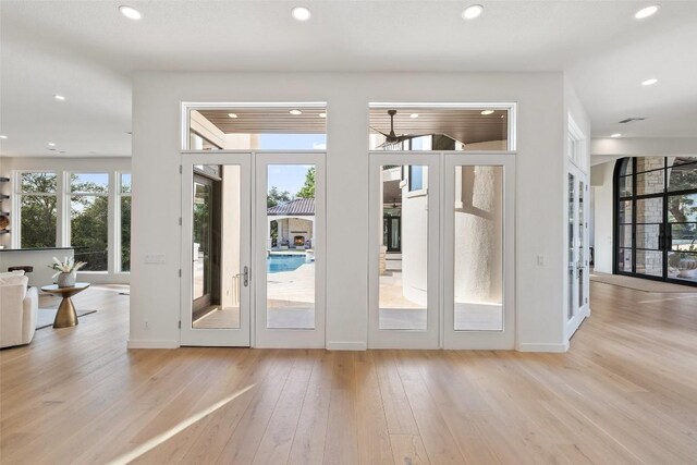 doorway to outside featuring baseboards, french doors, wood finished floors, and recessed lighting