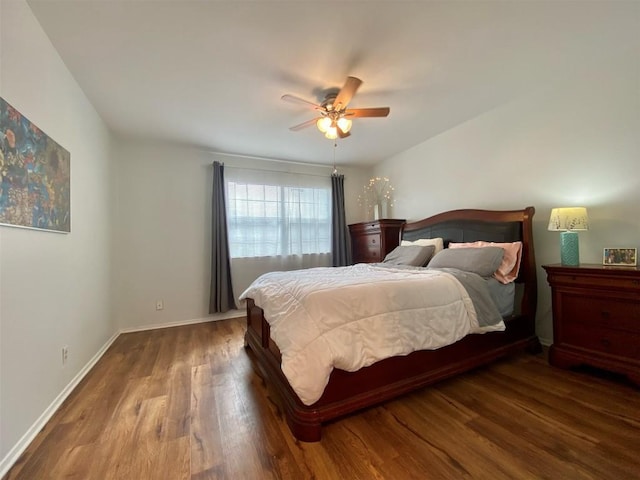 bedroom featuring ceiling fan, baseboards, and wood finished floors