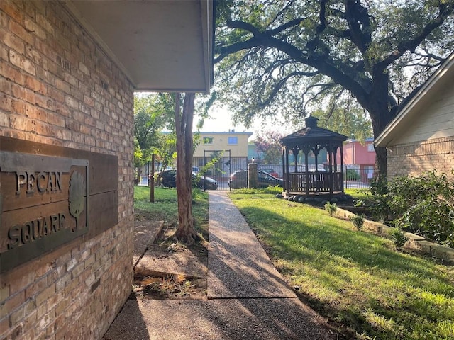 exterior space featuring a gazebo and fence