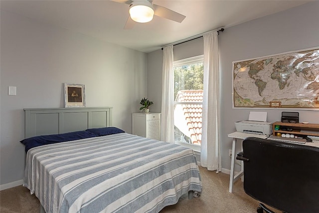 carpeted bedroom with baseboards and ceiling fan