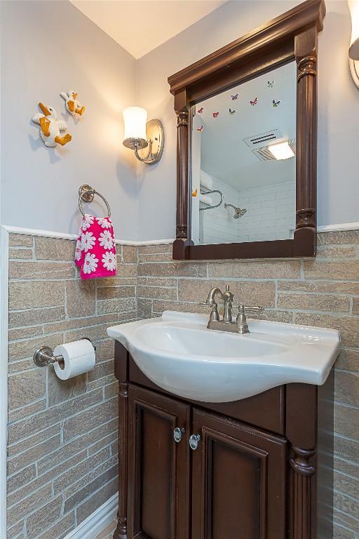 bathroom with wainscoting and vanity