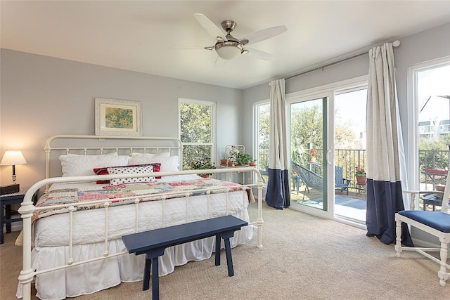 bedroom featuring carpet flooring, multiple windows, ceiling fan, and access to outside