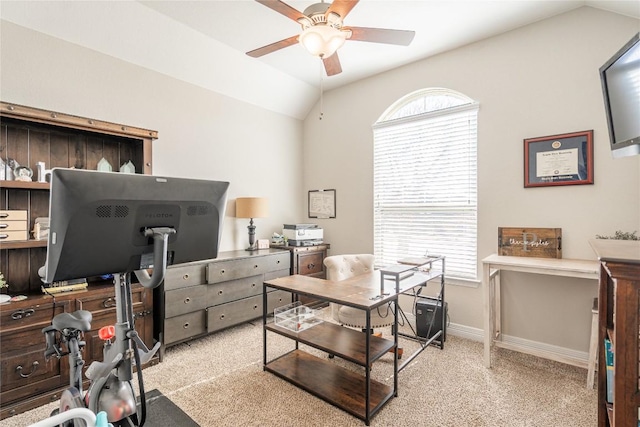 office area with a ceiling fan, lofted ceiling, light colored carpet, and baseboards