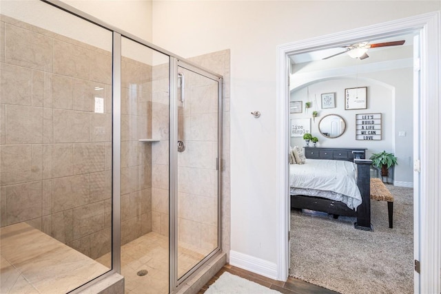 full bath featuring a stall shower, baseboards, a ceiling fan, and ensuite bathroom