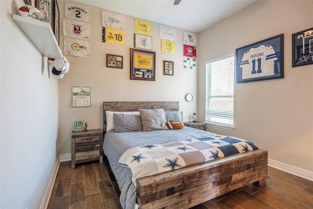 bedroom with wood finish floors, ceiling fan, and baseboards