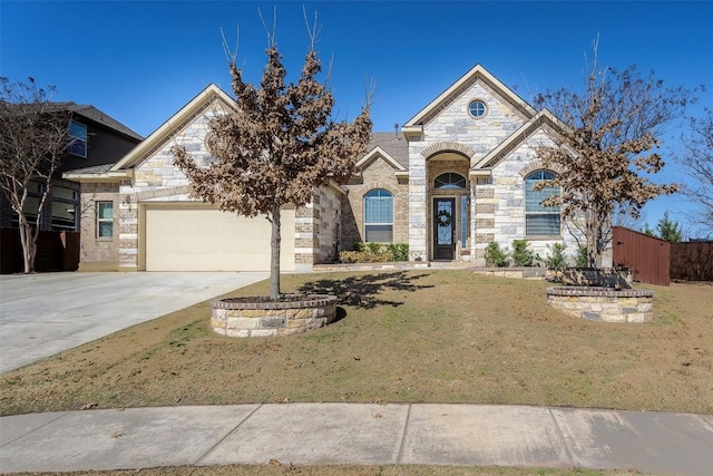 french country inspired facade featuring driveway, brick siding, a garage, and a front yard