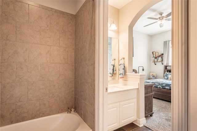 ensuite bathroom featuring vanity, tile patterned flooring, connected bathroom, and a ceiling fan