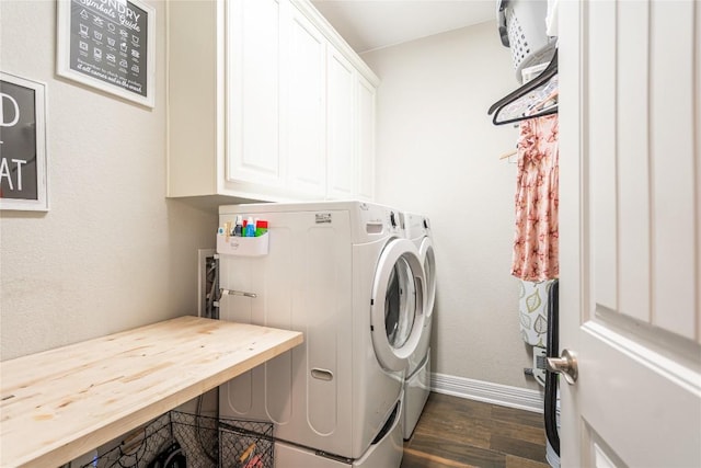 laundry room with dark wood-type flooring, washer and dryer, cabinet space, and baseboards