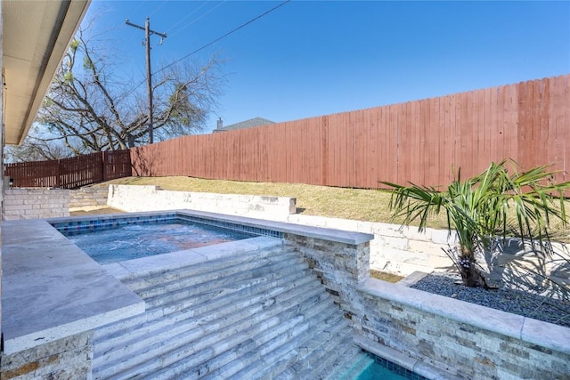 view of pool with a fenced backyard