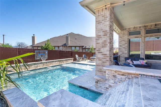 view of swimming pool with a patio, a fenced backyard, and a fenced in pool