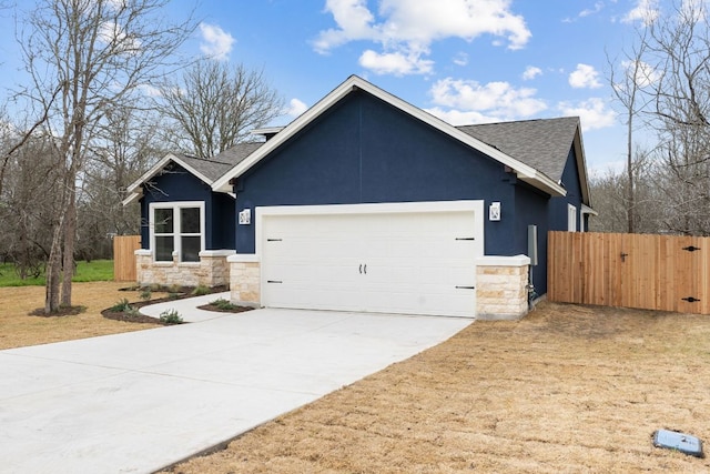 view of front facade featuring stucco siding, fence, a garage, stone siding, and driveway