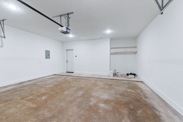 garage featuring baseboards, electric panel, and a garage door opener