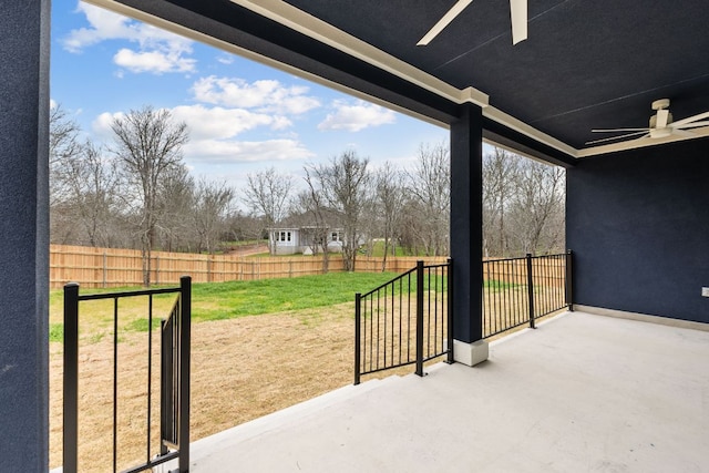 view of patio with ceiling fan and fence