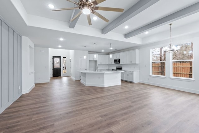 kitchen with appliances with stainless steel finishes, light wood-type flooring, and open floor plan