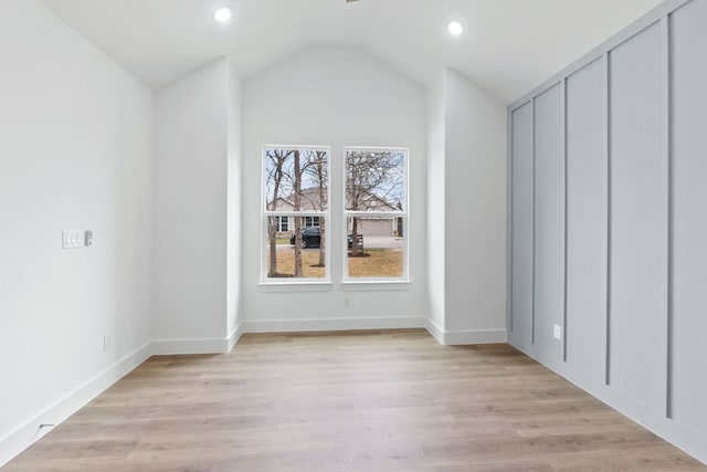 additional living space with lofted ceiling, light wood-style floors, baseboards, and recessed lighting