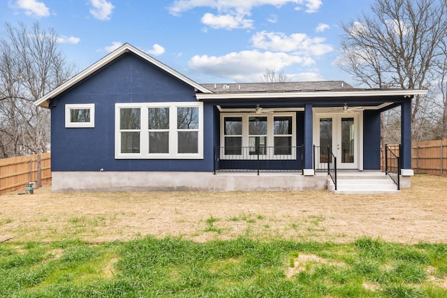 back of house with french doors, stucco siding, covered porch, ceiling fan, and fence